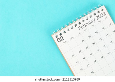 The February 2022 desk calendar on blue background with empty space. - Shutterstock ID 2112513989