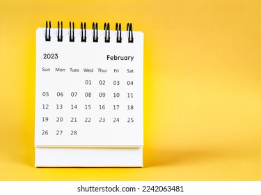 February 2023 desk calendar on yellow color background.