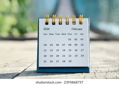February 2024 white calendar with green blurred background. New year concept.