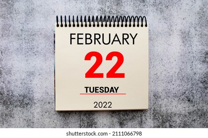 february 22. 22th day of month, calendar date. Stand for desktop calendar on beige wooden background. Concept of day of year, time planner, winter month.
