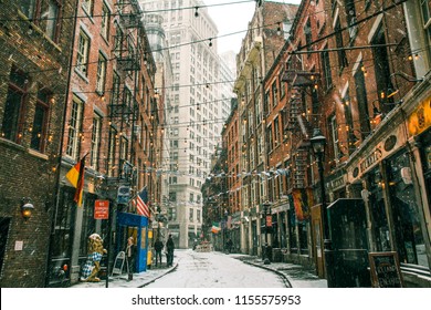 February 27th, 2015. New York, New York. Stone Street With String Lights Overhead And Old Brick Buildings Alongside In The Snow. 