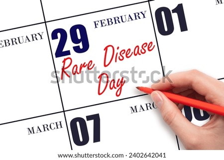 February 29. Hand writing text Rare Disease Day on calendar date. Save the date. Holiday.  Day of the year concept.