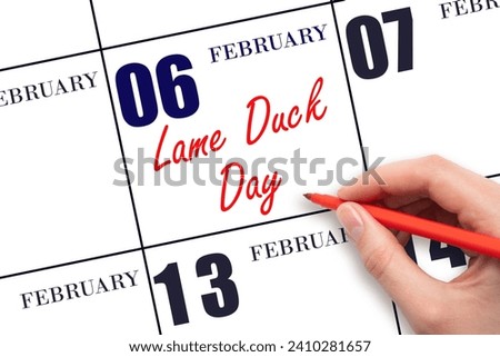 February 6. Hand writing text Lame Duck Day on calendar date. Save the date. Holiday.  Day of the year concept.