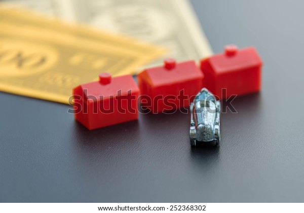 February 8, 2015 - Houston, TX, USA.  Monopoly\
money, car and red\
hotels