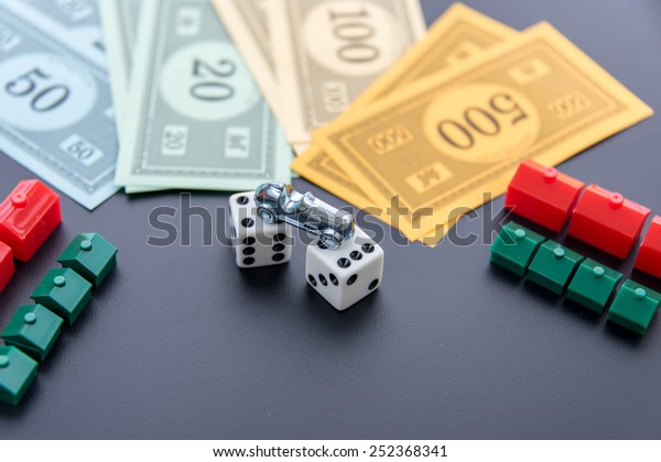 February 8, 2015 - Houston, TX, USA.  Monopoly\
car, dice, money, hotels and\
houses