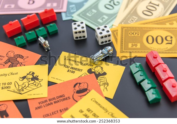 February 8, 2015 - Houston, TX, USA.  Monopoly\
money, playing pieces and\
cards