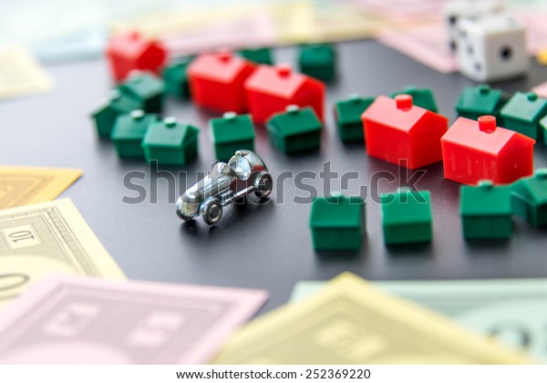 February 8, 2015 - Houston, TX, USA.  Monopoly\
money around houses and\
hotels