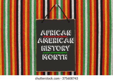 February Is African American History Month Blackboard Hanging On Striped Pattern Background