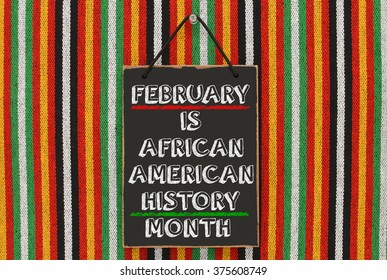 February Is African American History Month Blackboard Hanging On Striped Pattern Background