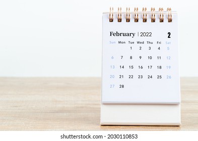 February calendar 2022 on wooden table background.