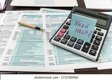 Federal 1040 tax form with sticker, calculator and pen. Financical documents. - Shutterstock ID 1715785966