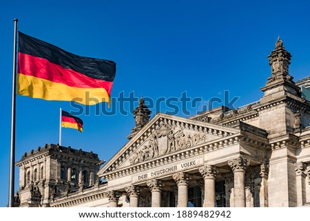 The federal flag in front of the impressive Reichstag in Berlin as a symbol of democracy