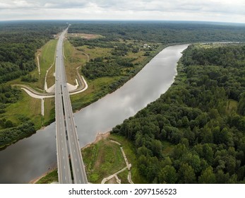 Federal Highway Bridge River In Summer Forest. Modern Straight Road Track. Moscow Saint Petersburg Motorway M11 Neva In Russia. Aerial Drone View. Flying Over. 