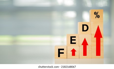 Federal Reserve bank Interest rates rise policy concept. Wooden blocks with fed and arrow point up.
