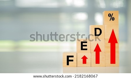 Federal Reserve bank Interest rates rise policy concept. Wooden blocks with fed and arrow point up.