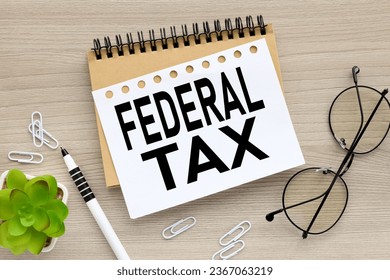 Federal tax. wood background words on notebook - Shutterstock ID 2367063219