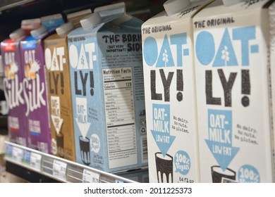 Federal Way, Washington - 07 18 2021: Oatly Brand Oat-milk Cartons For Sale In Grocery Store With Silk Brand Oat Milk Sharing Shelf Space.