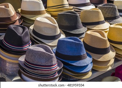 Fedora Hats In Various Colors Stacked On A Table Ready For Sale.