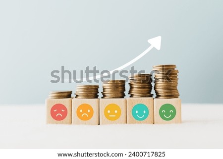 Feedback collection statistics saving finance business, credit score, wealthy concept, emoticon on wooden cube block with stack of coin above  