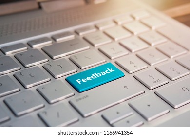 Feedback Computer keyboard with feedback button concept. Color button on the gray silver keyboard of modern ultrabook. caption on the button