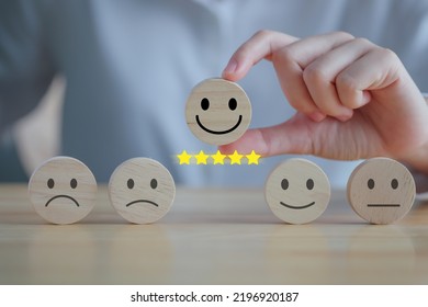 Feedback rating and positive service review. Customer experience, Mental health assessment, World mental health day, think positive, Emotion, satisfaction survey. Hand choosing happy face with 5 star. - Shutterstock ID 2196920187