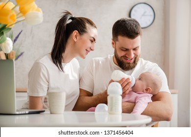 Feeding Baby Girl With Formula In A Bottle.