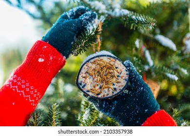 Feeding Birds In Winter. Woman With Bird Food.