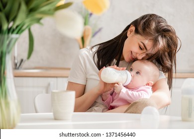 Feeding Newborn Girl With Formula In A Bottle.