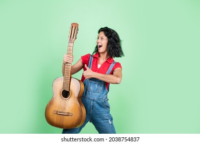 Feel Happiness And Joy. Happy Beautiful Lady Playing The Guitar. Music And Vocal. Female Country Singer. Cheerful Woman Sing And Play. Girl With Acoustic Guitar Instrument