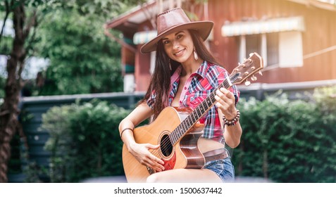 Feel the lifestyle. Beautiful cowgirl singer perfoming outdoors. Copy space on the right and on the left side