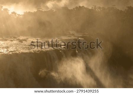 Feel profound awe watching dramatic iguazu falls flow with heavy mist