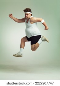 I feel in shape already. Overweight man leaping in the air with his sense of achievement.