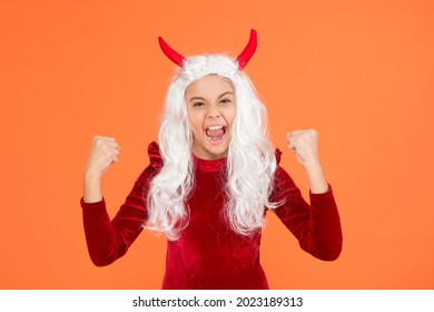 Feel The Success. Happy Halloween Devil Girl. Shouting Teenage Child In Imp Horns. Cheerful Kid Has White Hair. Spooky And Creepy. Carnival Costume Party. Trick Or Treat. Celebrate The Holidays