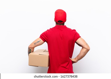 feeling confused or full or doubts and questions, wondering, with hands on hips, rear view. delivery concept - Powered by Shutterstock
