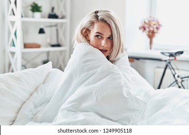 Feeling Cozy. Attractive Young Woman Looking Away While Covering With Blanket In Bed At Home                    