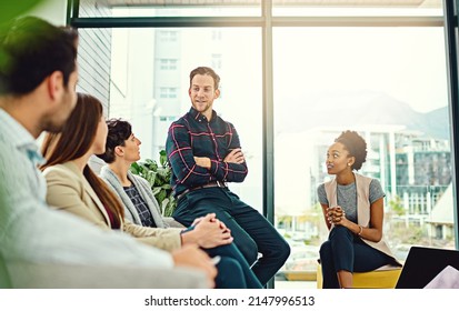 Feeling Eager About A New Project. Cropped Shot Of A Group Of Colleagues Having A Discussion In An Office.