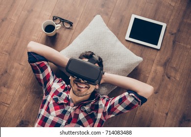 Feeling Good. High Angle Of Serene Freelancer, Using Vh Set, Resting On The Floor At Home, Enjoying, Chilling. Hitech Recreational Entertainment. Brunet With Bristle, In Checkered Shirt