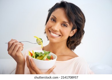 Feeling Good Starts With Eating Right. Portrait Of A Young Woman Enjoying A Salad At Home.