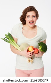 Feeling Great. Happy Young Woman Holding A Variety Of Fruit And Veg.