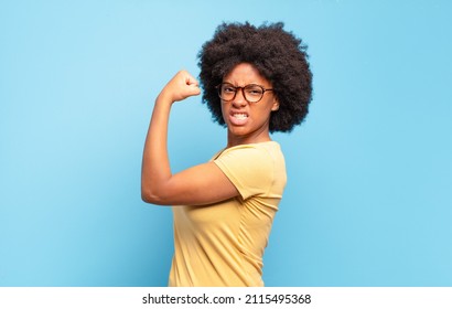  feeling happy, satisfied and powerful, flexing fit and muscular biceps, looking strong after the gym - Shutterstock ID 2115495368