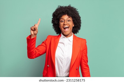  feeling like a happy and excited genius after realizing an idea, cheerfully raising finger, eureka! - Shutterstock ID 2311258175