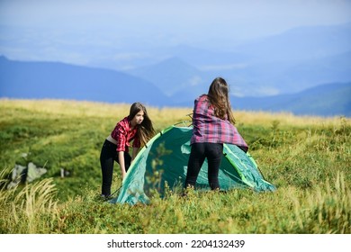 Feeling Playful. Friends Spend Free Time Together. Family Camping. Reach Destination Place. Two Girls Pitch Tent. Wanderlust Discovery. Hiking Outdoor Adventure. Mountain Tourism Camp