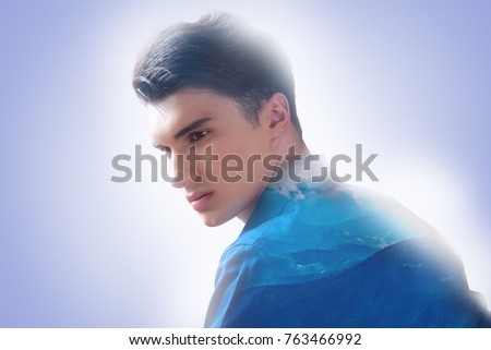 Feeling relaxed. Nice good looking handsome man sitting and thinking about nature while feeling relaxed