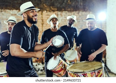Feeling the rhythm in the drums. Shot of a group of musical performers playing together indoors. - Shutterstock ID 2149633721