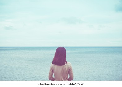 Feeling sad mood concept. Copy space of loneliness woman looking view of beach background. Vintage tone filter effect color style. 