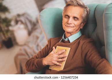 Feeling Secure. Retired Man Feeling Rather Secure While Spending His Leisure Time With Loving Family