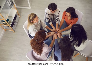 Feeling Strong Together. Happy Women Holding Hands, Sitting In Circle In Group Meeting With Coach Or Therapy Session With Psychotherapist. Concert Of Unity, Power And Support. From Above, High Angle