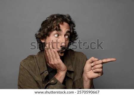 feeling surprised with a shocked expression and pointing to the side