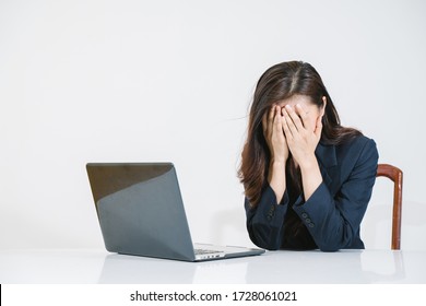 Feeling tired and stressed. Frustrated young woman keeping eyes closed and massaging nose while sitting at her working place in office.