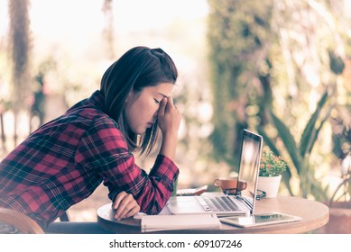 Feeling tired and stressed young woman of working age is working on a wooden table in the garden with evening sunlight
 - Shutterstock ID 609107246